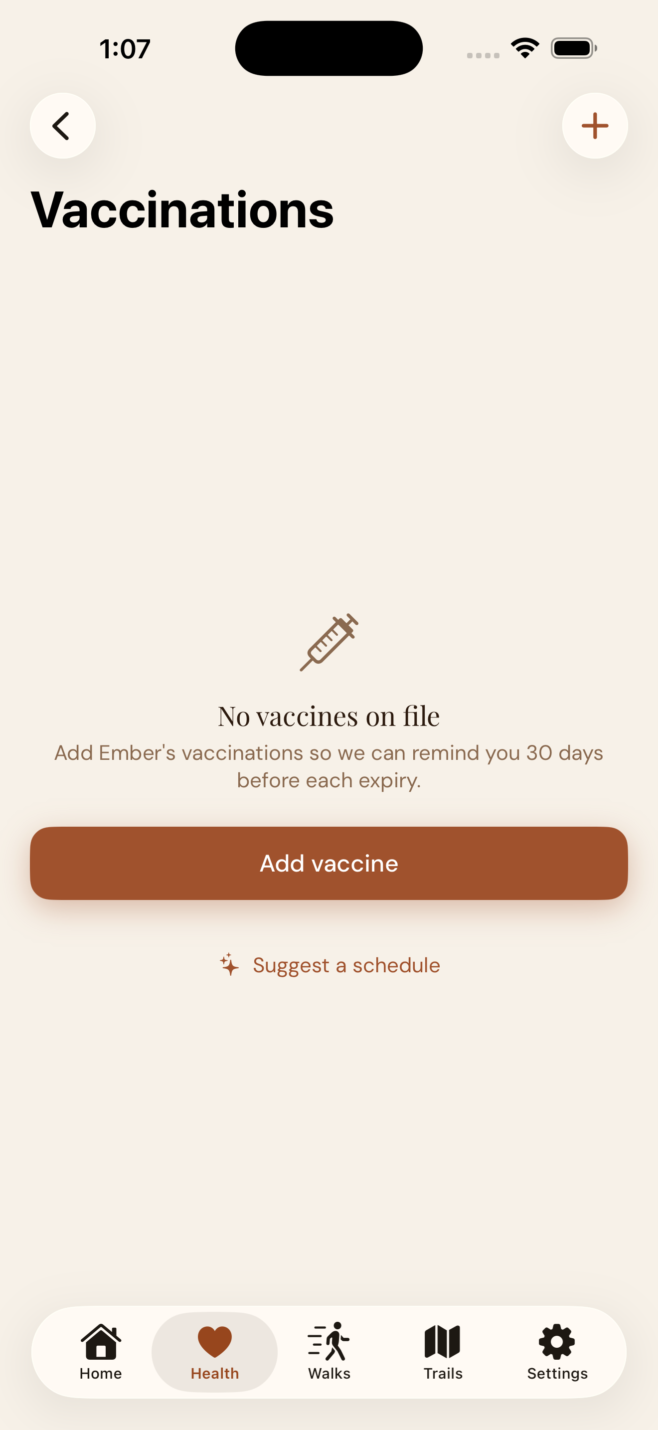 EmberPaws Vaccinations — empty state with an Add vaccine button and a Suggest a schedule link that auto-builds a baseline canine vaccine schedule from your dog's age